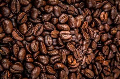 close-up of coffee beans background - coffee stock pictures, royalty-free photos & images
