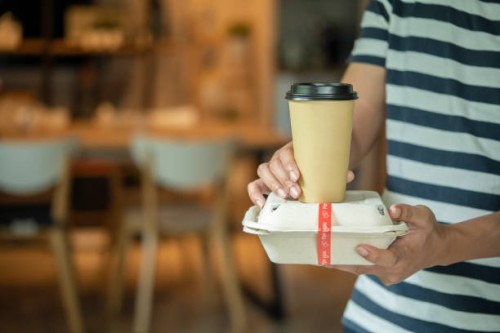 close-up of delivery man handing a slack of foam lunch box - junk food stock pictures, royalty-free photos & images