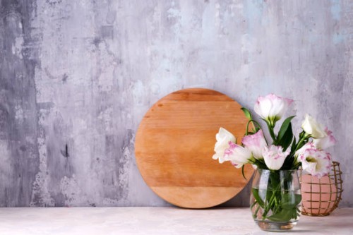 close-up of eustoma flowers in vase on table against wall - garden decoration stock pictures, royalty-free photos & images