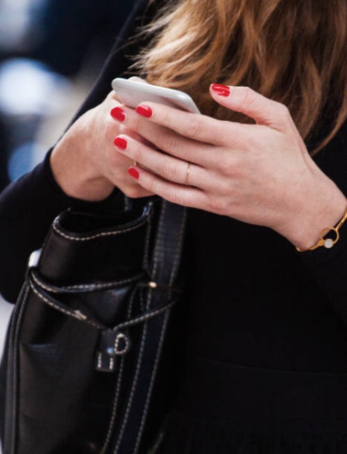 close-up of female hands in diamond jewelry hold a phone in expensive rim - fashion week stock pictures, royalty-free photos & images