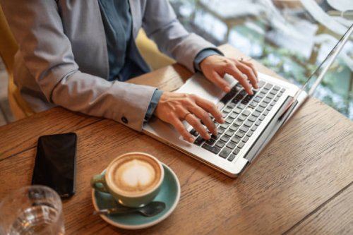 close-up of female hands, working online, typing on laptop - coffee stock pictures, royalty-free photos & images