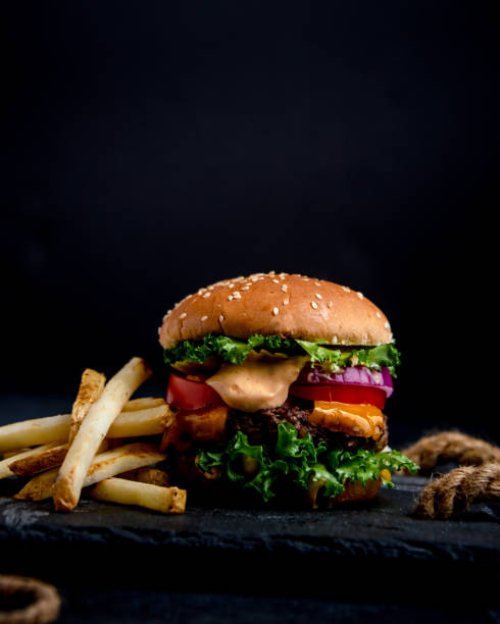 close-up of hamburger with black background - junk food stock pictures, royalty-free photos & images
