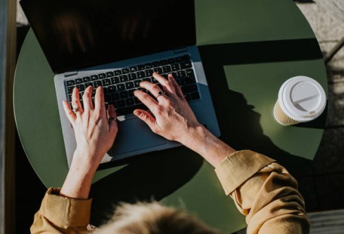 close-up of hands typing on a laptop computer - coffee stock pictures, royalty-free photos & images