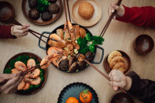 close-up of joyful three generations asian family having reunion dinner together in dining room and celebrating chinese new year at home. - food stock pictures, royalty-free photos & images