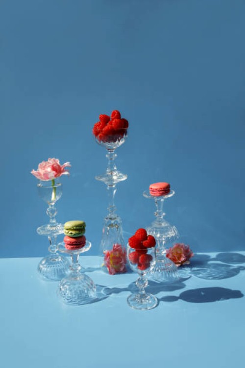 close-up of macarons and pink flowers on the blue background - food stock pictures, royalty-free photos & images