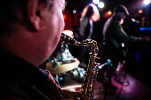 close-up of man playing saxophone on a live concert - concert stock pictures, royalty-free photos & images