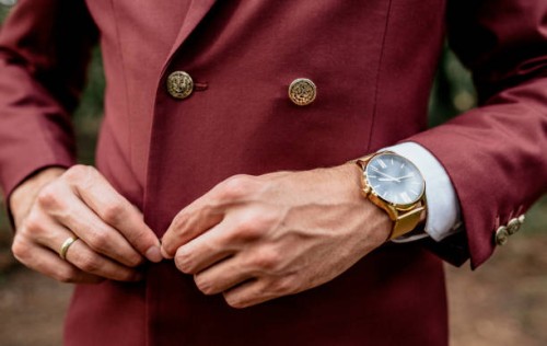 close-up of man wearing a suit and golden watch buttoning his jacket - fashion stock pictures, royalty-free photos & images