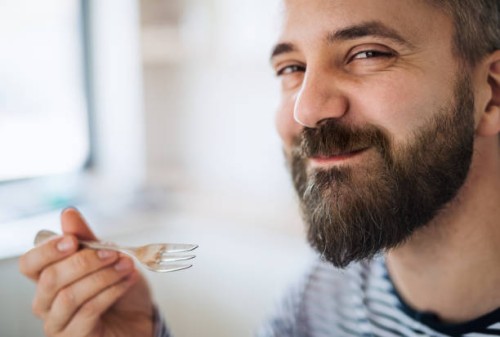 close-up of mature man indoors at home, eating cake. - food stockfoto's en -beelden