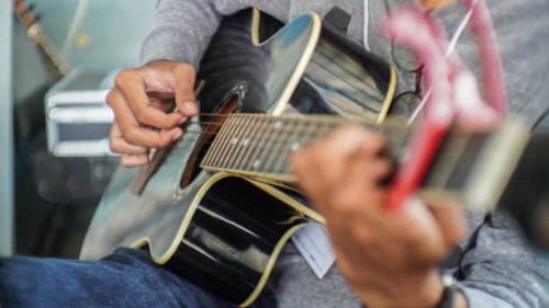 close-up of person playing guitar - concert stock pictures, royalty-free photos & images