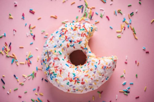 close-up of white donuts with multi colored sparks - junk food stock pictures, royalty-free photos & images