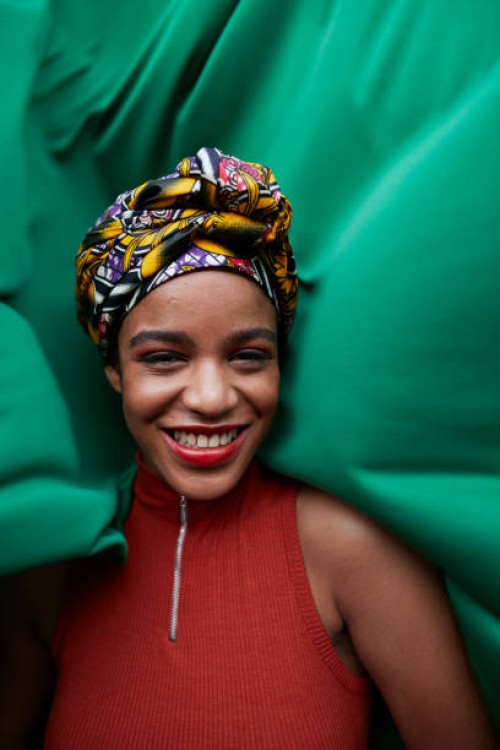 close-up of woman in headwear against green textile - fashion stock pictures, royalty-free photos & images