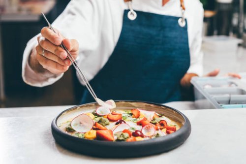 close up a chef preparing a gourmet dish. chef is decorating the plate just before the serving. - food stock pictures, royalty-free photos & images