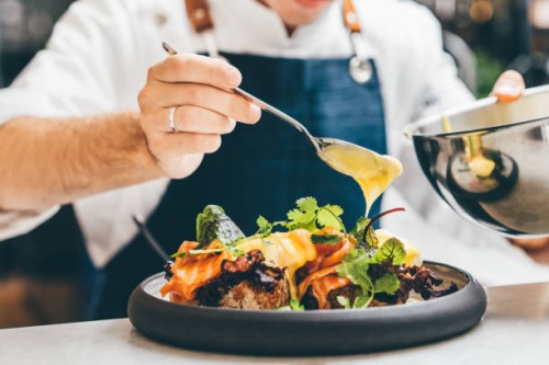 close up image of a chef preparing a gourmet dish. chef is decorating the plate just before the serving. - food stock pictures, royalty-free photos & images