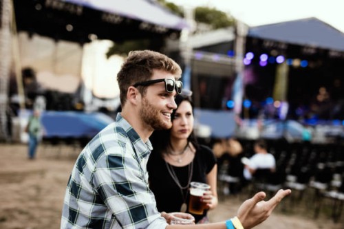 close up of a handsome guy explaining how is overjoyed to be at jazz music festival. depth of field - concert stock pictures, royalty-free photos & images