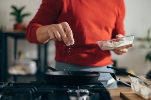 close up of anonymous man adding salt to a meal - food stock pictures, royalty-free photos & images