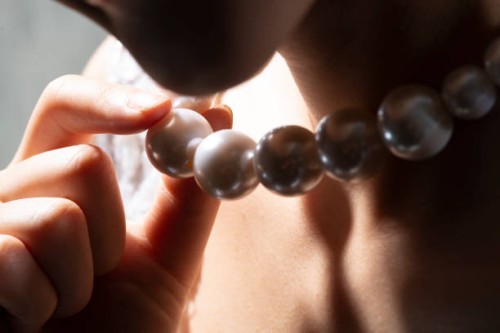 close up of bride holding pearl necklace - fashion stock pictures, royalty-free photos & images