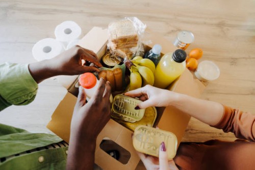 close up of couple donating food for poor people - food stock pictures, royalty-free photos & images