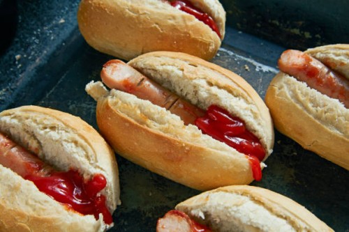 close up of frankfurters in hot dog roll as dissected fingers - junk food stock pictures, royalty-free photos & images