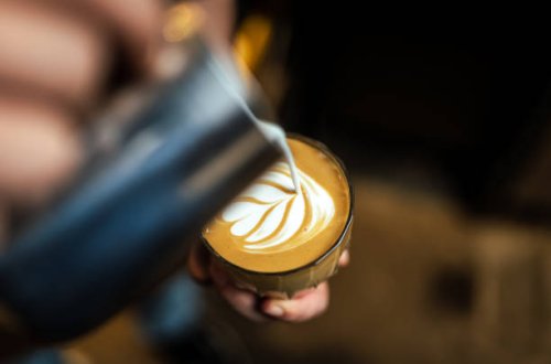 close up of hand pouring coffee latte art - coffee stock pictures, royalty-free photos & images