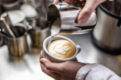 close up of hand pouring coffee latte art. barista pouring latte art photography. - coffee stock pictures, royalty-free photos & images