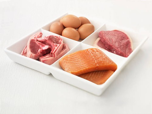 close up of sectioned plate with eggs, pork, salmon and steak - food stock pictures, royalty-free photos & images