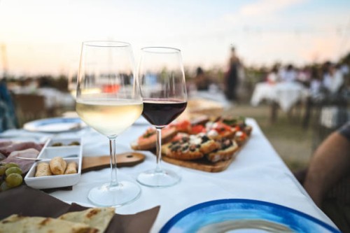 close up of two wine glasses on table in a restaurant outdoors. - food stock pictures, royalty-free photos & images