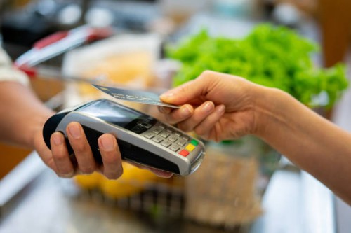 close up of unrecognizable customer doing a contactless payment at the supermarket - food stock pictures, royalty-free photos & images