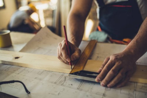 close up of unrecognizable worker drawing on wood plank. - home decoration stock pictures, royalty-free photos & images