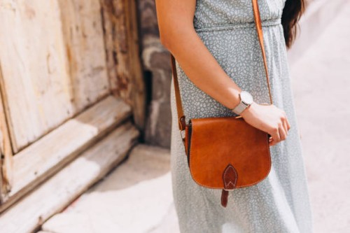 close up of woman gripping a small leather purse - fashion stock pictures, royalty-free photos & images
