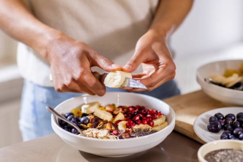 close up of woman making healthy breakfast in kitchen with fruits and yogurt - food stock pictures, royalty-free photos & images