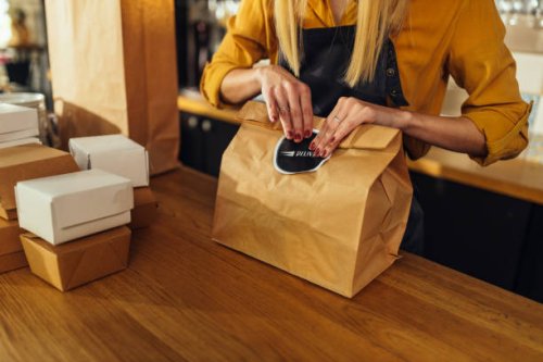 close up of woman packing food for delivery - junk food stock pictures, royalty-free photos & images