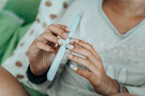 close up of woman with long, slender finger spolishing - nails art stock pictures, royalty-free photos & images