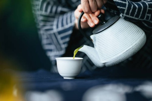 close up photo of woman hands pouring matcha green tea from teapot into a cup - home decoration stock pictures, royalty-free photos & images