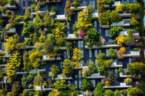 close up shot of modern skyscraper with green trees and colorful plants on balconies like a vertical forest in milano, italy - garden decoration stock pictures, royalty-free photos & images
