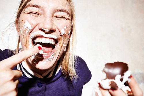 close up studio shot of young woman with face covered in chocolate marshmallow - food stock pictures, royalty-free photos & images