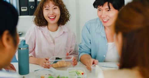 closeup of cheerful asian team enjoys a sustainable lunch break in the office, highlighting environmental responsibility and social inclusion. esg sustainable business office. - junk food stock pictures, royalty-free photos &