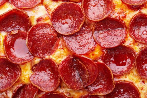 closeup of pepperoni pizza as a background - junk food stock pictures, royalty-free photos & images