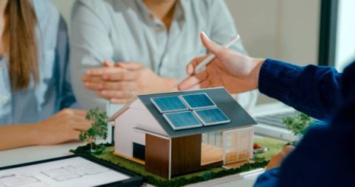closeup of young asian couple in detailed consultation with real estate agent, who is highlighting advantages of home with solar panels. consulting on eco-friendly home with real estate agent. - home decoration stock pictures