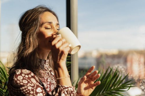 closeup portrait of woman drinking coffee in the morning at home - coffee stock pictures, royalty-free photos & images