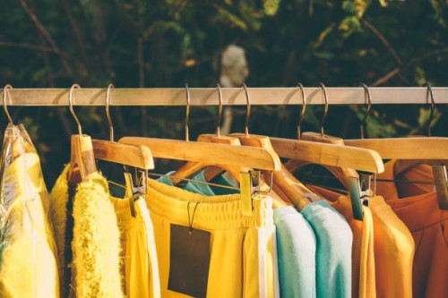 clothes hang on a shelf in a designer clothes store - fashion stock pictures, royalty-free photos & images