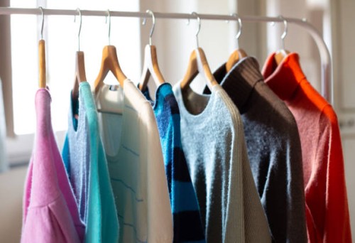 clothes rail with colorful cashmere sweaters - fashion stock-fotos und bilder