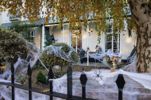 Cobwebs and other decorations are arranged around a garden to mark Halloween on 31 October 2020 in Windsor, United Kingdom. Halloween celebrations,...