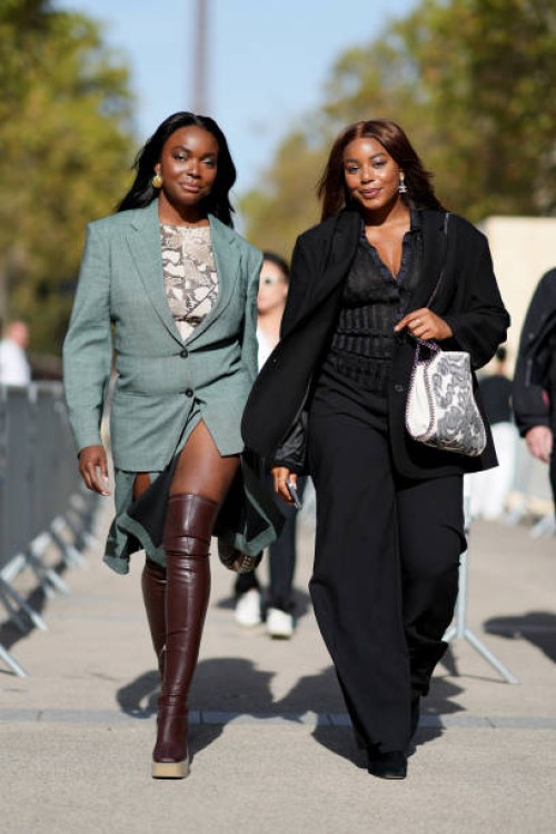 Coco Bassey wears a green oversized blazer jacket ; Kaye Bassey wears a black oversized blazer jacket, outside Stella McCartney, during the...
