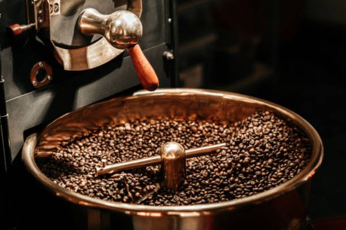 coffee beans being cooled after being roasted from a coffee roaster machine - coffee stock pictures, royalty-free photos & images