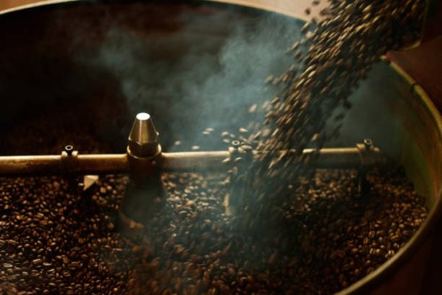 coffee beans dark roast pouring to cooling batch after finish process roasting coffee beans - coffee stockfoto's en -beelden