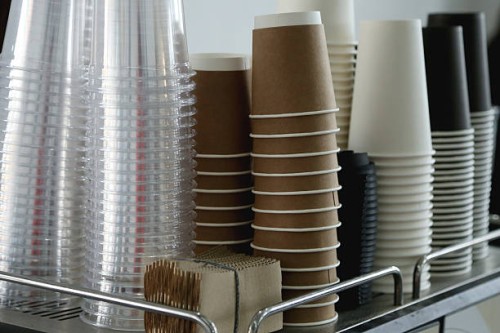 coffee corner with stack of brown paper disposable coffee cup and plastic glasses for mocktails - junk food stock pictures, royalty-free photos & images