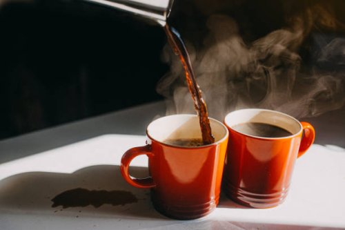 coffee pouring in two mugs - coffee stock pictures, royalty-free photos & images