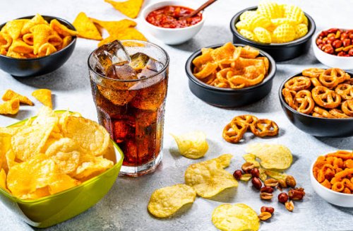 cola soda glass and salty snacks shot on gray table - junk food stock pictures, royalty-free photos & images