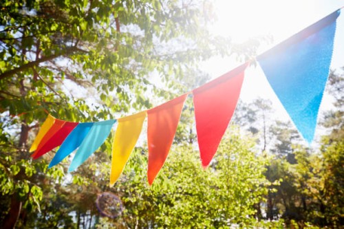 colorful bunting flags/ pennant chain for party decoration in garden - garden decoration stock pictures, royalty-free photos & images