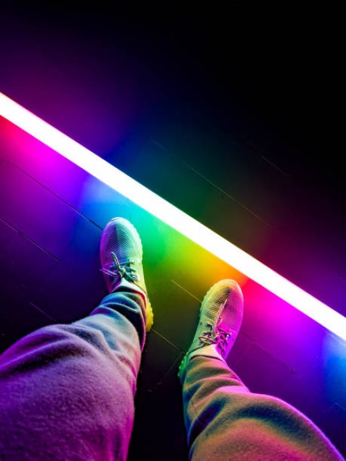 colorful led tube illuminating escenario with person. - fashion stock pictures, royalty-free photos & images